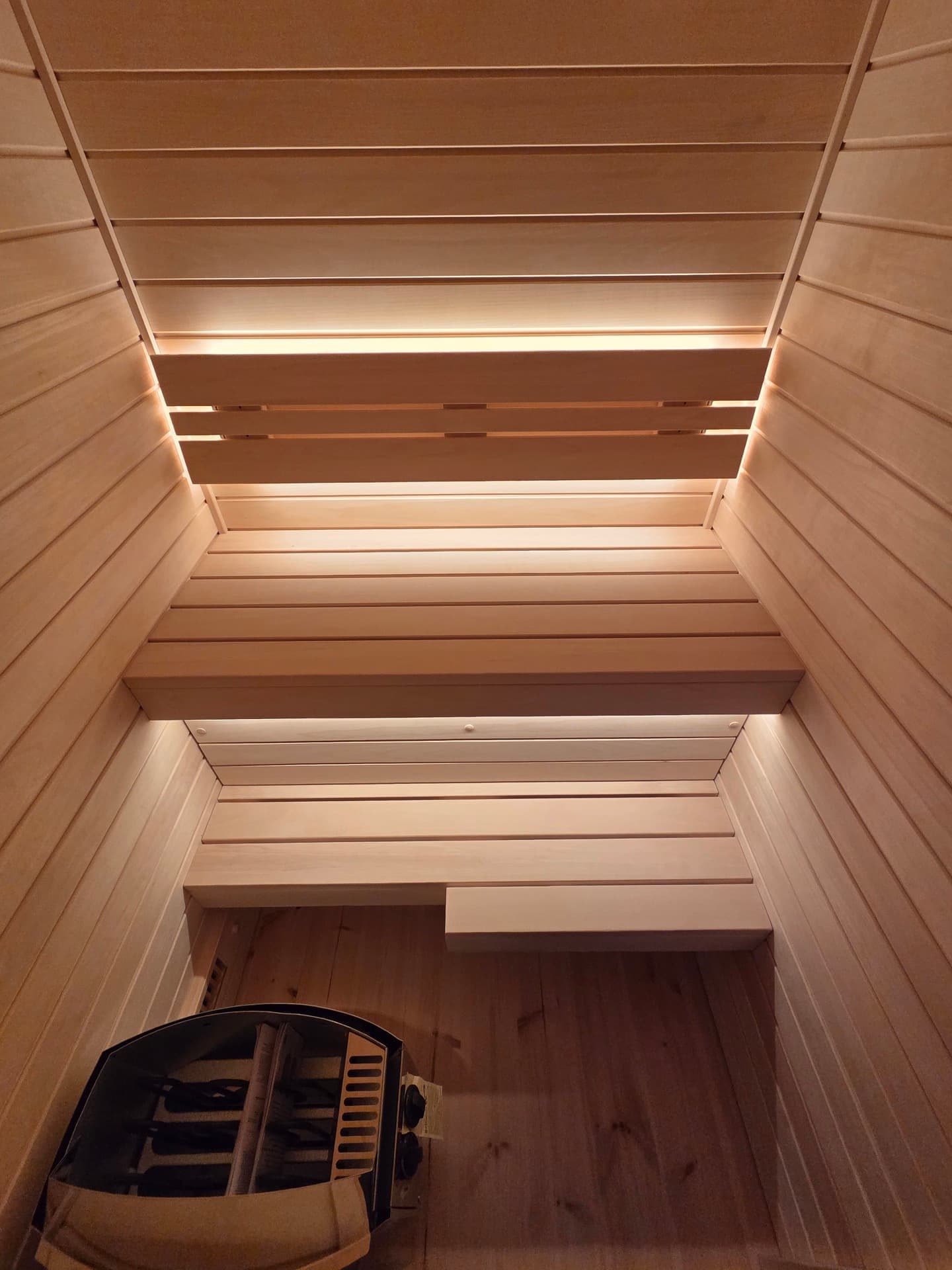 The ceiling and both benches, lit by the strip beneath the backrest