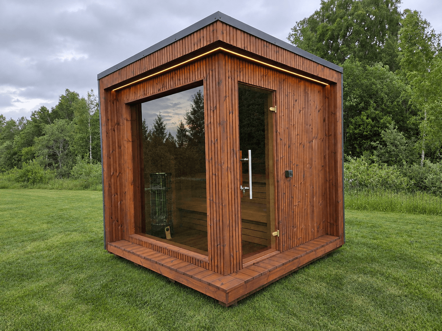 Modern garden sauna with panoramic glazing and Thermowood exterior